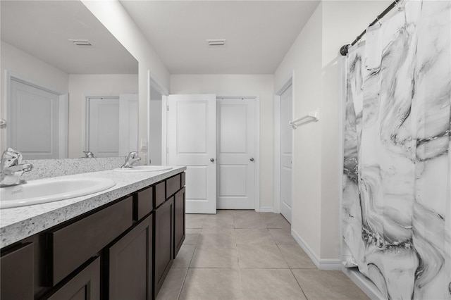 bathroom with a shower with shower curtain, tile patterned flooring, and vanity