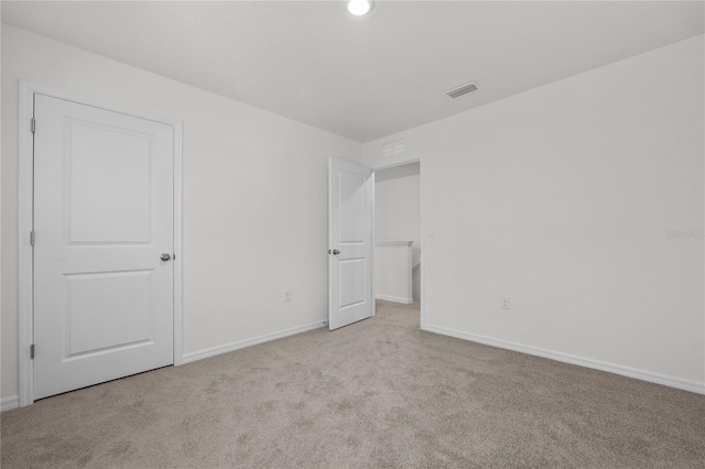 unfurnished bedroom with light colored carpet