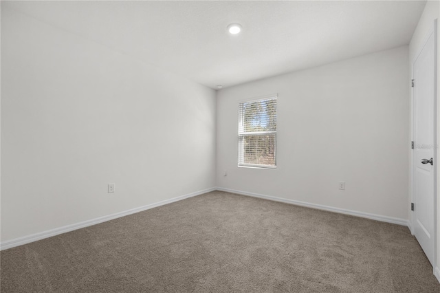 unfurnished room featuring carpet