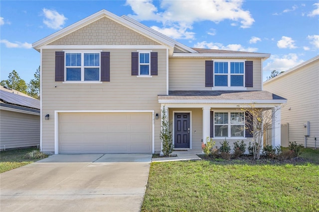 view of front of home with a front lawn and a garage