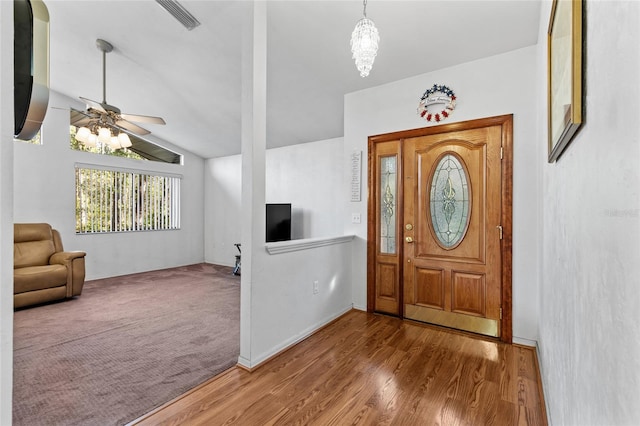 entryway with wood-type flooring, ceiling fan, and vaulted ceiling