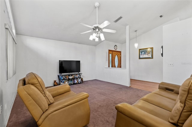 carpeted living room with ceiling fan and vaulted ceiling