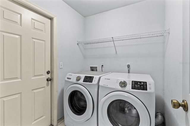 clothes washing area with washer and clothes dryer