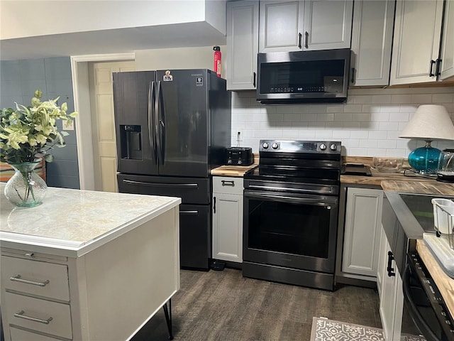 kitchen with appliances with stainless steel finishes, gray cabinetry, and backsplash