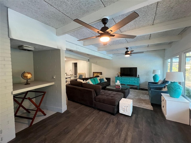 living room featuring dark wood-type flooring, ceiling fan, and beamed ceiling