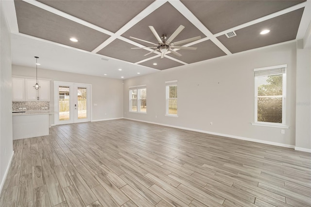 unfurnished living room featuring ceiling fan, coffered ceiling, light hardwood / wood-style floors, and french doors