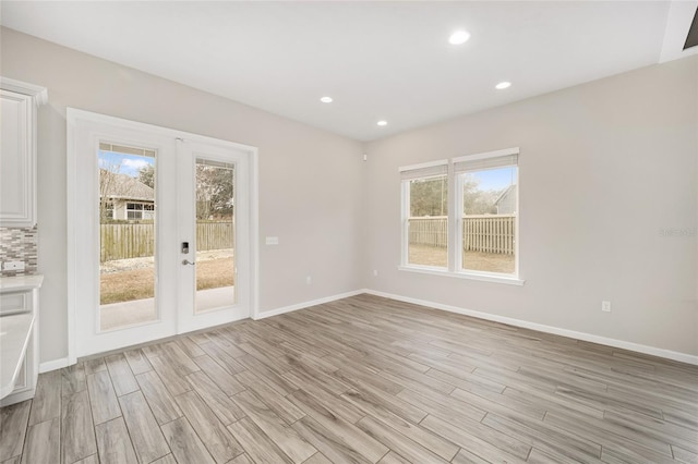 spare room featuring a wealth of natural light and french doors