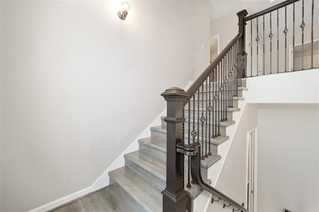 stairway featuring wood-type flooring