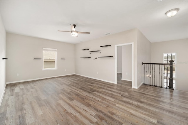 empty room featuring ceiling fan and light hardwood / wood-style flooring