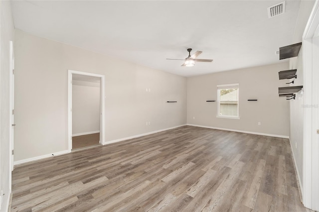 empty room featuring ceiling fan and light wood-type flooring