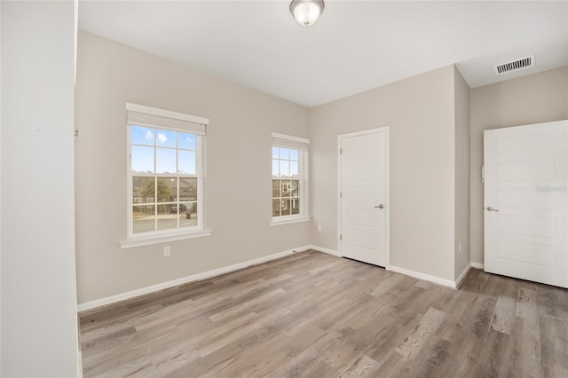 unfurnished bedroom with light hardwood / wood-style floors and a closet