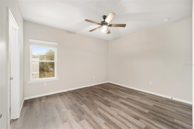 empty room with hardwood / wood-style flooring and ceiling fan