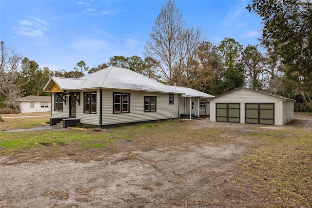 view of front of home with a garage and an outdoor structure