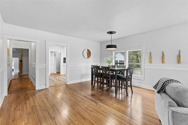 dining room with light wood-style flooring and baseboards