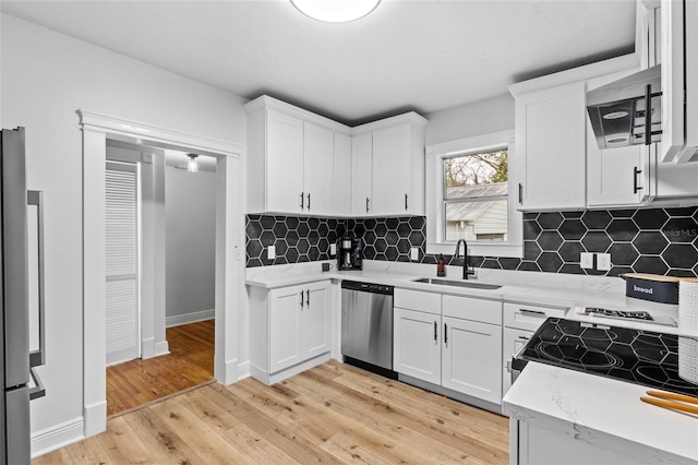 kitchen featuring white cabinets, appliances with stainless steel finishes, and sink