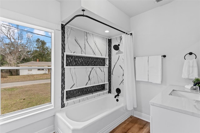 bathroom with wood-type flooring, vanity, and shower / bath combination with curtain