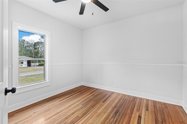 unfurnished room with baseboards, ceiling fan, and hardwood / wood-style floors