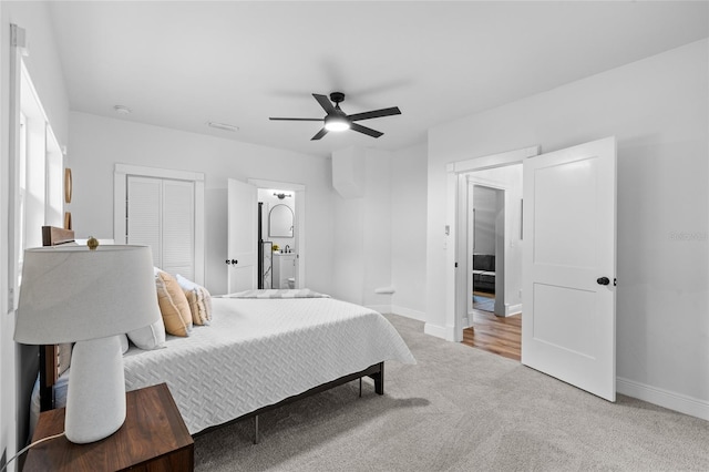 bedroom with carpet floors, a closet, baseboards, and a ceiling fan