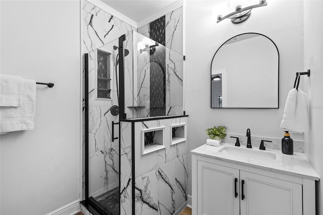 bathroom featuring a marble finish shower and vanity