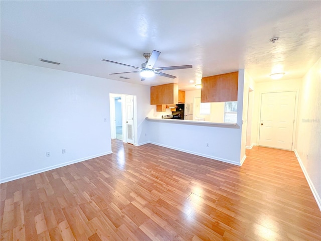 unfurnished living room with light hardwood / wood-style floors and ceiling fan