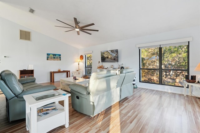 living room featuring light hardwood / wood-style floors, ceiling fan, and vaulted ceiling