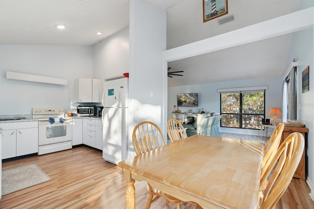 dining room with high vaulted ceiling, light hardwood / wood-style flooring, and ceiling fan