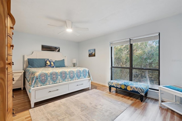 bedroom with ceiling fan and light hardwood / wood-style flooring