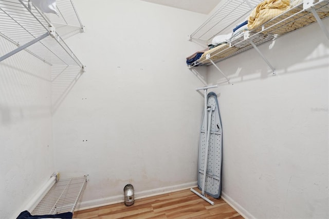 clothes washing area with hardwood / wood-style floors