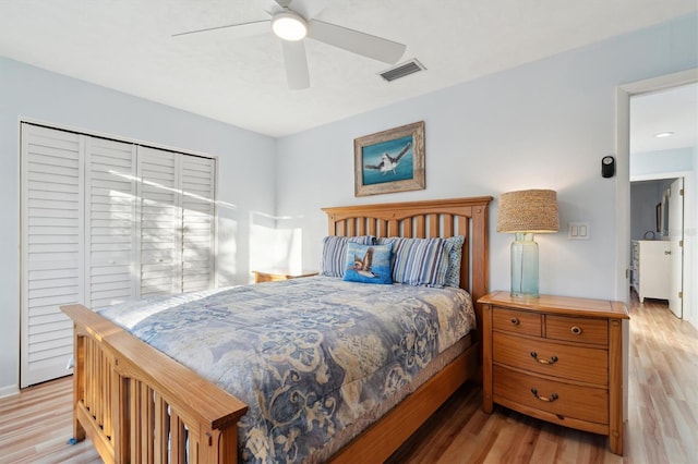 bedroom with ceiling fan, a closet, and light hardwood / wood-style floors