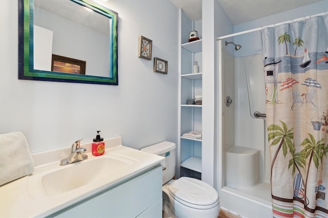 bathroom featuring toilet, vanity, a shower with curtain, and built in features