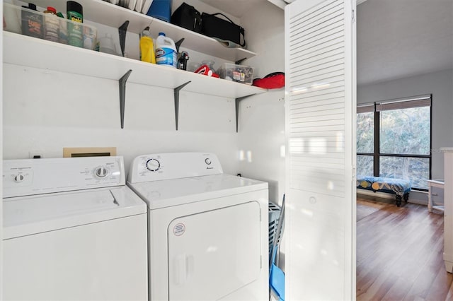 washroom with washer and dryer and hardwood / wood-style floors