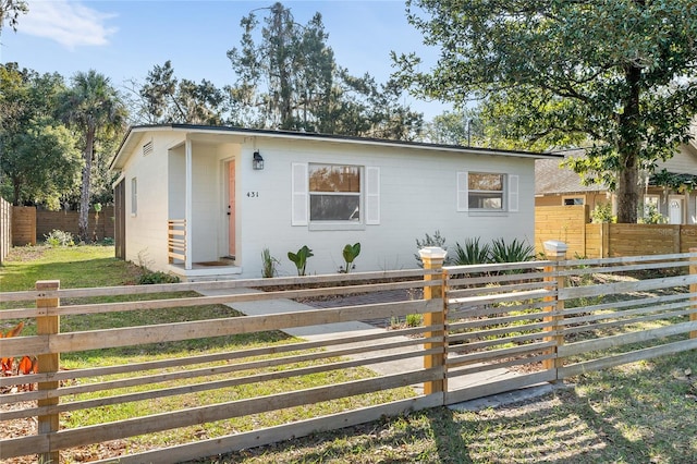 view of front of house with fence private yard and concrete block siding