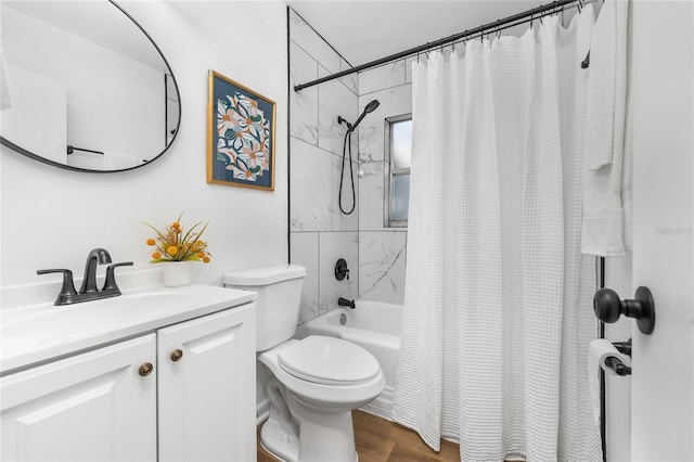 full bathroom with toilet, shower / bath combo with shower curtain, wood finished floors, and vanity