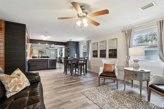 living room with ceiling fan and light hardwood / wood-style flooring