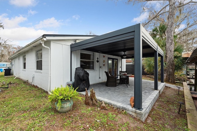 exterior space with ceiling fan and a grill