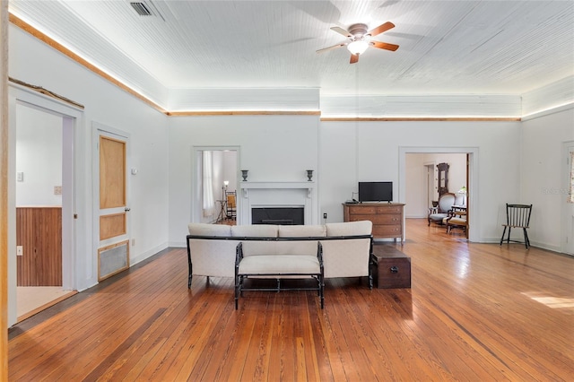 living room with ceiling fan and hardwood / wood-style flooring