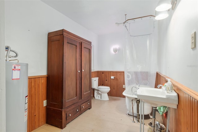 bathroom with electric water heater and toilet