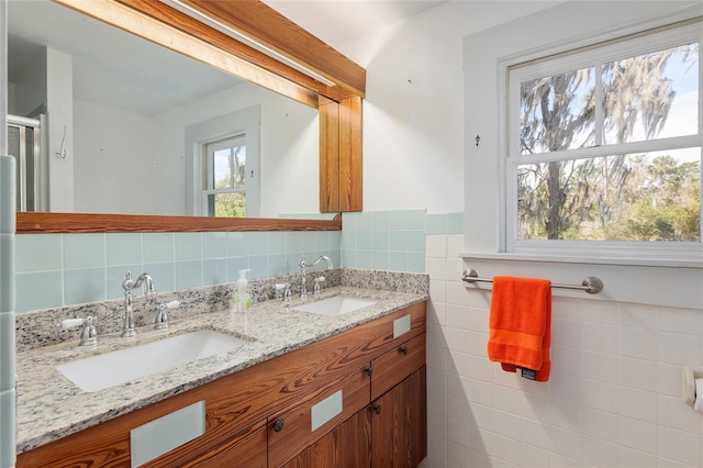 bathroom featuring tile walls and vanity