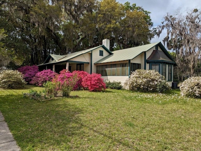 view of front of home featuring a sunroom and a front yard