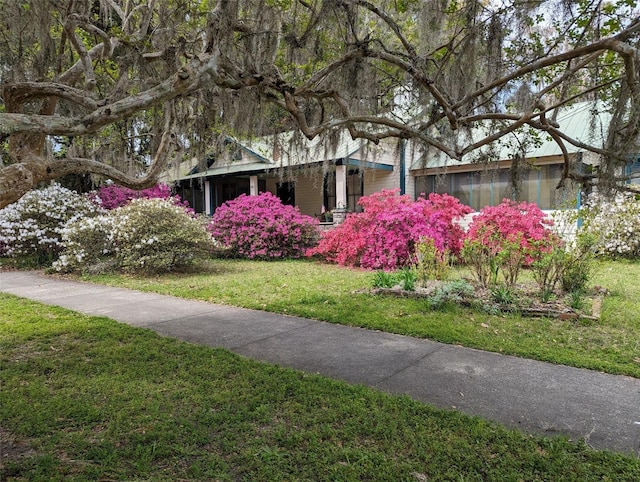 view of side of property featuring a yard