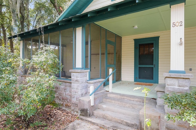 view of exterior entry featuring a porch