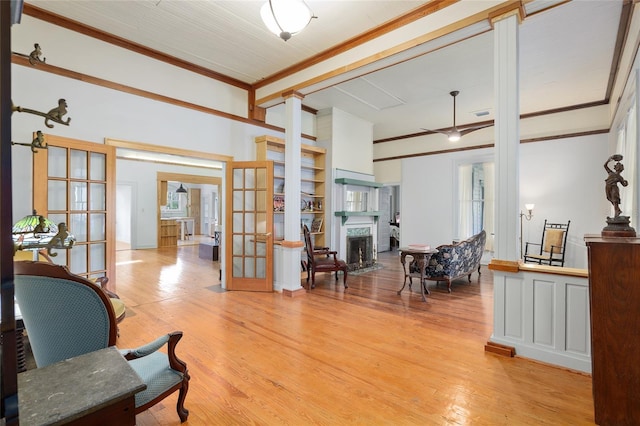 interior space with ornamental molding, light hardwood / wood-style floors, and french doors