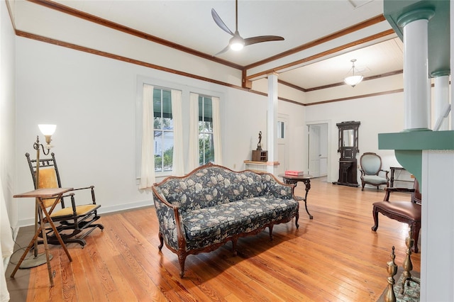 living room featuring ceiling fan, crown molding, and light hardwood / wood-style flooring