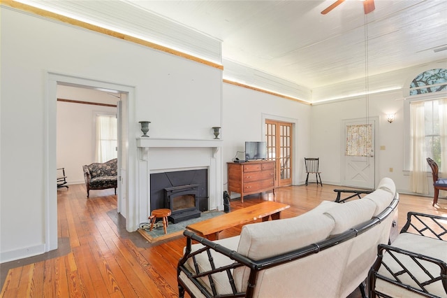 living room featuring ceiling fan, plenty of natural light, and hardwood / wood-style floors