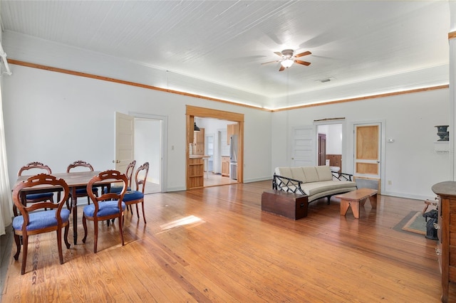 living room featuring ceiling fan and light hardwood / wood-style floors