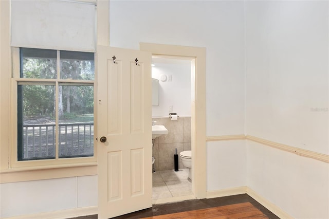 bathroom with toilet and tile patterned flooring