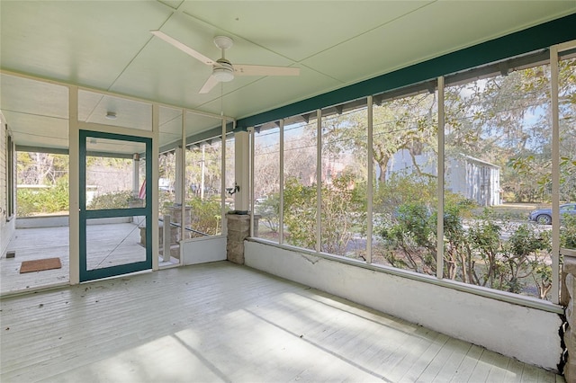 unfurnished sunroom featuring ceiling fan