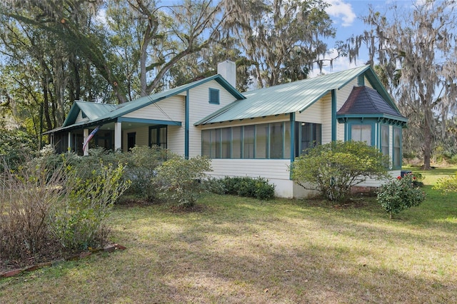 exterior space with a front yard and a sunroom