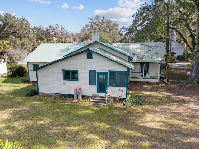 rear view of property with a lawn