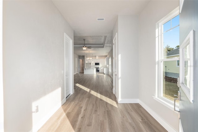 corridor with light hardwood / wood-style floors